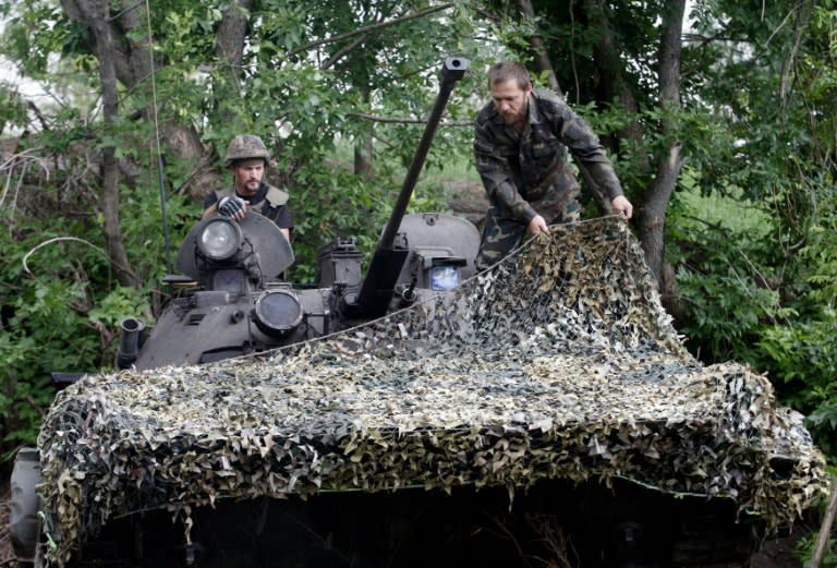 Ukrainian servicemen prepare to go to a position on the frontline with pro-Russian separatists near Starognativka, in Ukraine's Donetsk region, on July 2, 2015