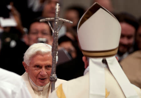 FILE PHOTO: Pope Francis (R) greets former Pope Benedict during a consistory ceremony in Saint Peter's Basilica at the Vatican February 22, 2014. REUTERS/Alessia Giuliani/File Photo