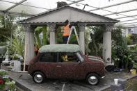 A worker helps construct a stand during preparations for the Chelsea Flower Show in London. Tickets for the show topped £300 earlier in the week- setting you back more than a Coldplay gig would.