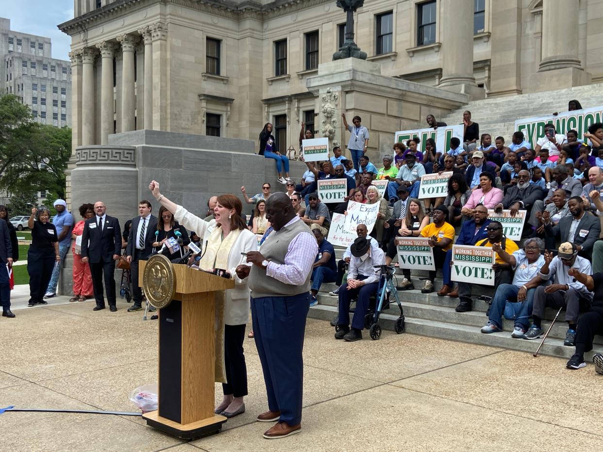 Left to right, Brittany Caldwell and Rev. Greggory Divinity, as well as more than 120 others shout "full expansion now," Tuesday on the Southern steps of the Mississippi State Capitol Building at 400 High St. Caldwell and Divinity were two of several religious leaders to urge lawmakers to fully expand Medicaid in Mississippi for more than 160,000 people and declare April 16 as Medicaid Expansion Day.