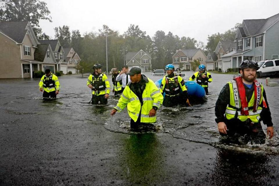 Members of the North Carolina Task Force urban search and rescue team wade through a flooded neighborhood looking for residents who stayed behind as Florence continues to dump heavy rain in Fayetteville, N.C., Sunday, Sept. 16, 2018. Photo by David Goldman/AP.