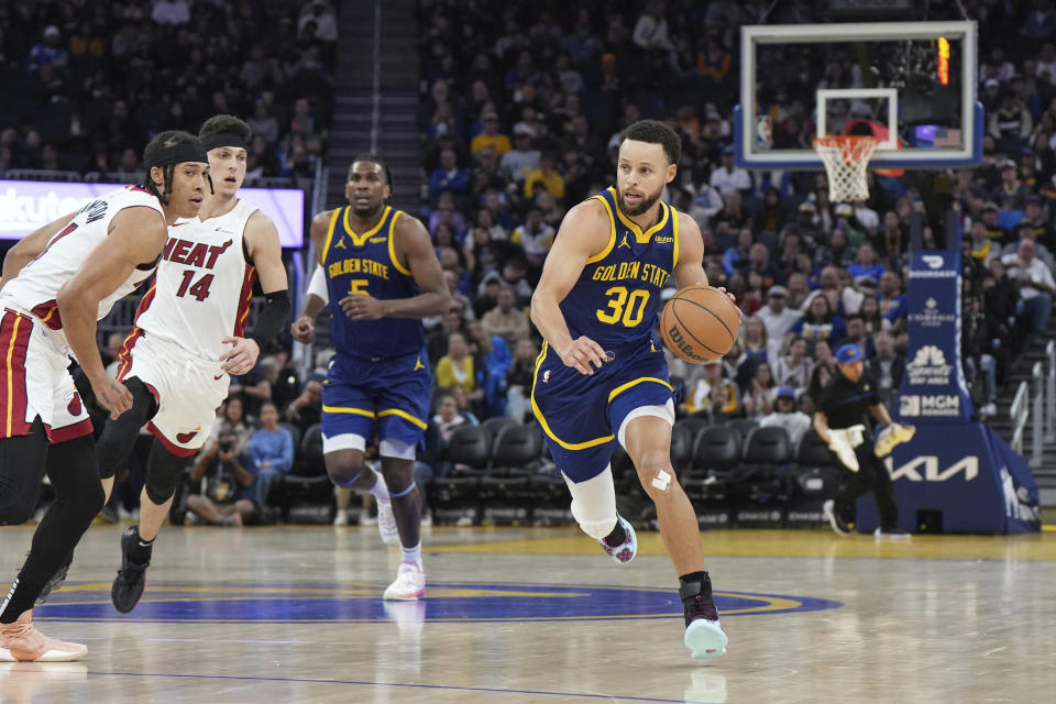 Golden State Warriors guard Stephen Curry (30) brings the ball up during the second half of the team's NBA basketball game against the Miami Heat on Thursday, Dec. 28, 2023, in San Francisco. (AP Photo/Loren Elliott)