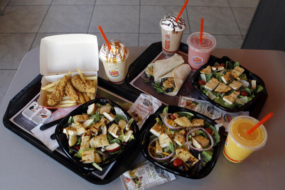 In this March 28, 2012 photo, new food items sit on display at a Burger King restaurant in Miami. Burger King launches 10 menu items including smoothies, frappes, specialty salads and snack wraps in a star-studded TV ad campaign. It's the biggest menu expansion since the chain opened its doors in 1954. (AP Photo/Luis M. Alvarez)