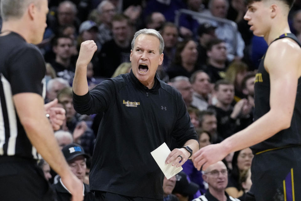 FILE - Northwestern head coach Chris Collins, center, cheers for his team during the second half of an NCAA college basketball game against Purdue in Evanston, Ill., Sunday, Feb. 12, 2023. Purdue's Matt Painter and Northwestern's Chris Collins split coach of the year honors in the Big Ten in voting released by The Associated Press Tuesday, March 7, 2023. (AP Photo/Nam Y. Huh, File)