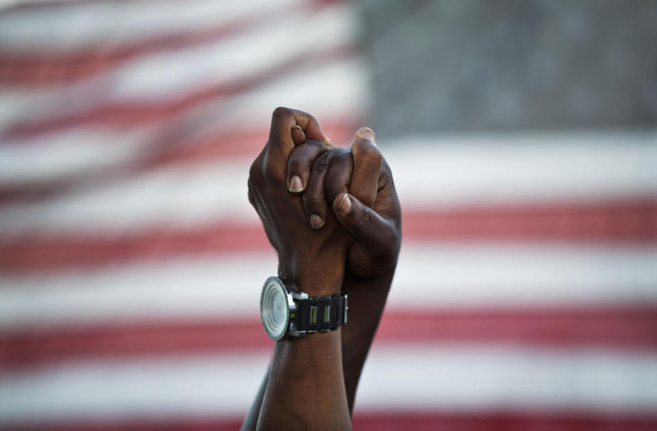 <p>People join hands against the backdrop of an American flag as thousands of marchers meet in the middle of Charleston’s main bridge in a show of unity after nine black church parishioners were gunned down during a Bible study, June 21, 2015, in Charleston, S.C. (AP Photo/David Goldman) </p>