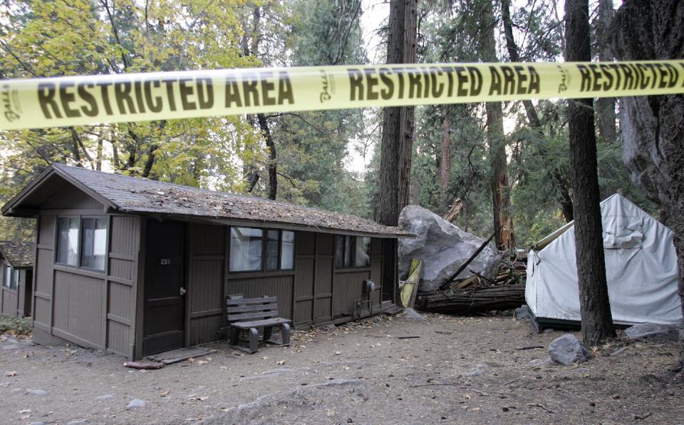 FILE - In this Monday, Oct. 20, 2008 file photo, restriction tape blocks an area at Curry Village in Yosemite National Park, Calif., after a boulder fell during a rock slide. Falling boulders are the single biggest force shaping Yosemite Valley, one of the most popular tourist destinations in the nation’s system of national parks. Now large swaths of popular haunts deemed unsafe are closing as officials acknowledge they knew for more than a decade ago that unsuspecting tourists were being lodged in harm’s way. On Thursday, June 14, 2012, the National Park Service will announce that potential danger from the unstable 3,000-foot-tall slab of granite known as Glacier Point, a picturesque promontory that for decades has provided a dramatic backdrop to park entertainment events, will leave uninhabitable large parts of Yosemite Valley’s most popular lodging areas. (AP Photo/Paul Sakuma)