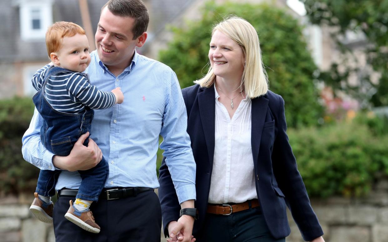 Douglas Ross, the newly announced Scottish Conservative leader, poses for a picture with his wife Krystle and his son Alistair  -  RUSSELL CHEYNE/REUTERS