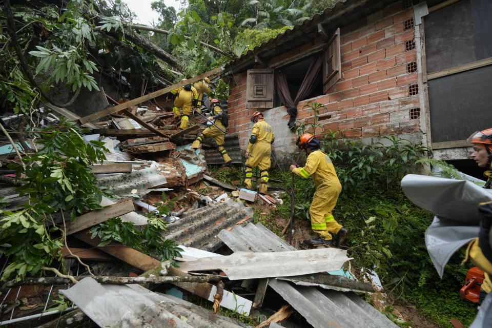 Rescue workers search for survivors after flooding triggered deadly landslides near Juquehy beach in Sao Sebastiao, Brazil, Monday, Feb. 20, 2023. (AP Photo/Andre Penner)