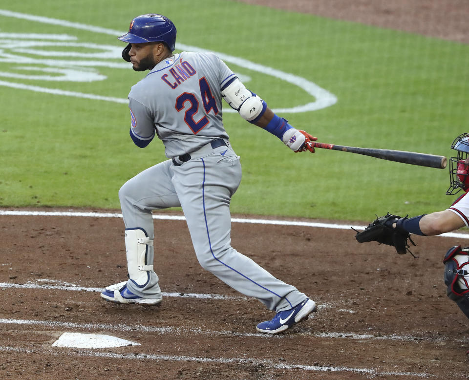 New York Mets Robinson Cano watches a two-run single against the Atlanta Braves during the third inning of a baseball game Monday, Aug. 3, 2020, in Atlanta. (Curtis Compton/Atlanta Journal-Constitution via AP)