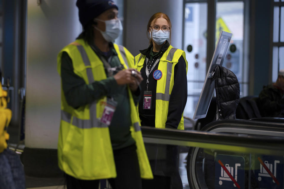 FILE - In this Friday, Jan. 24, 2020 file photo, airport employees wear face masks in Terminal 5 at O'Hare International Airport in Chicago. On Friday, Jan. 31, 2020, The Associated Press reported on stories circulating online incorrectly asserting that chlorine dioxide will help get rid of the new virus from China. The U.S. Food and Drug Administration warns that drinking products containing the chemical can cause nausea, vomiting, diarrhea and symptoms of severe dehydration. (E. Jason Wambsgans/Chicago Tribune via AP)