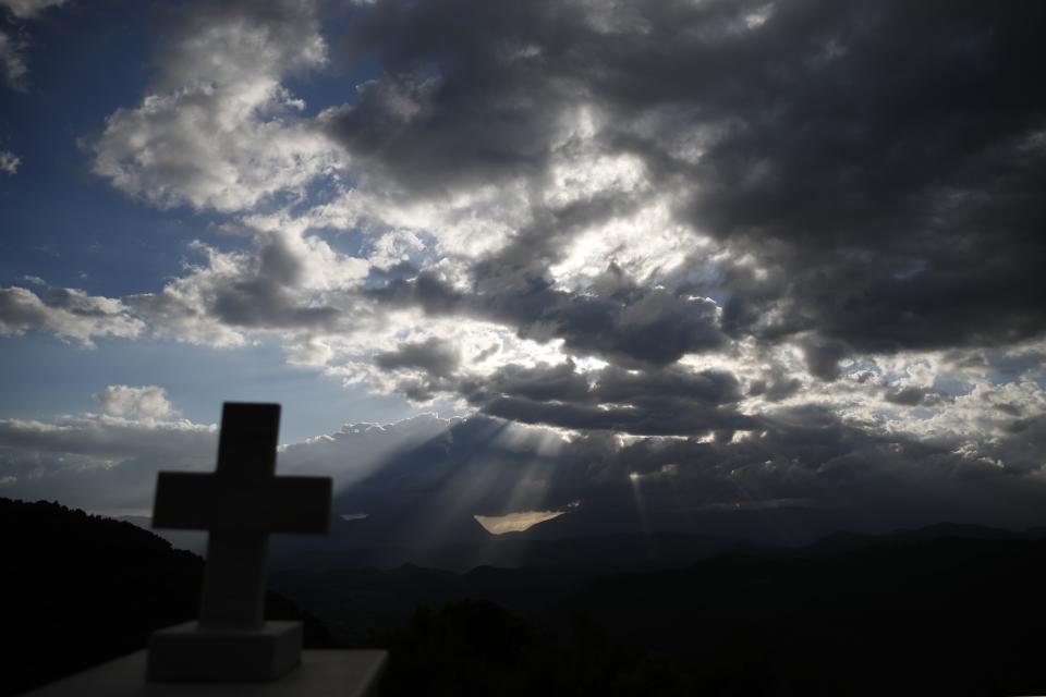 In this Tuesday, May 14, 2019, photo the sun sets over the mountains of Evrytania region, in central Greece. The area, a winding, three-hour drive from Athens, has the oldest population in the whole European Union, 54.3 on average. (AP Photo/Thanassis Stavrakis)