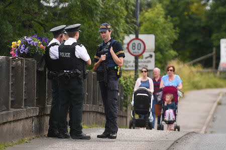Officers of the Northern Ireland Police Service chat with a colleague from Ireland's Garda at the exact borderline between Northern Ireland and Ireland in St Belleek, in Fermanagh, Northern Ireland, July 19, 2018. REUTERS/Clodagh Kilcoyne