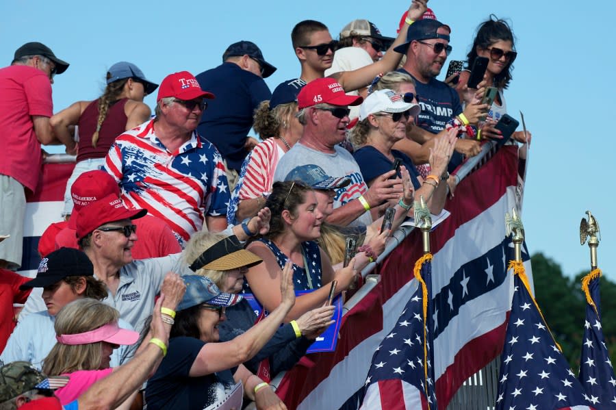 Supporters wave to Republican presidential candidate former President Donald Trump at a campaign rally in Chesapeake, Va., Friday, June 28, 2024. (AP Photo/Steve Helber)