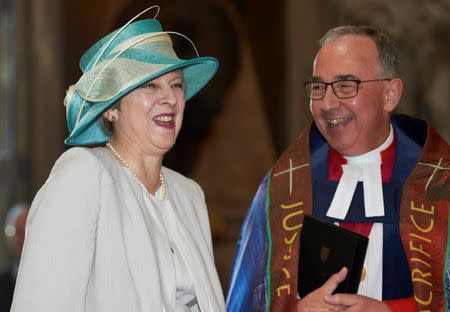 Britain's Prime Minister Theresa May is greeted by the Dean of Westminster John Hall as she arrives for a Service of Thanksgiving to mark the 70th anniversary of the landing of the Windrush, at Westminster Abbey, London, Britain, June 22, 2018. Niklas Halle'n/Pool via REUTERS