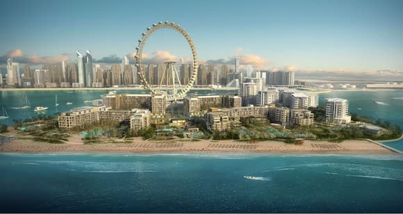 Caesars development in Dubai showing a beachfront resort and ferris wheel..