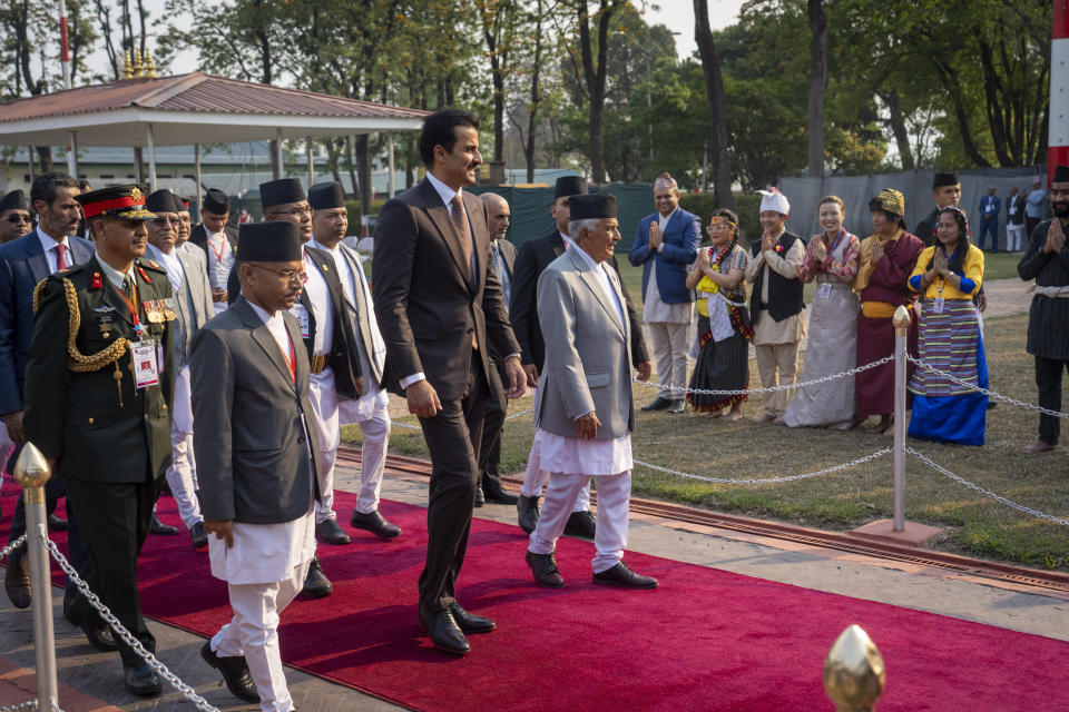 Qatar's Emir Sheikh Tamim bin Hamad Al Thani, is received by Nepal President Ram Chandra Poudel, right as he arrives at the airport in Kathmandu, Nepal, Tuesday, April 23, 2024. The emir is on a two-days visit to the Himalayan nation. (AP Photo/Niranjan Shreshta)