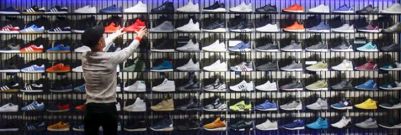 FILE PHOTO: A shop assistant works at the Adidas flagship store in Berlin, Germany, January 20, 2016. REUTERS/Hannibal Hanschke/File Photo
