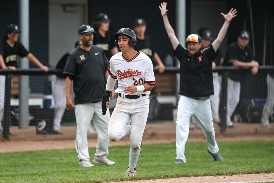Brighton's Trent Mailloux heads home with the winning run while coach Charlie Christner raises his arms in the district championship game against Howell on Saturday, June 4, 2022 in East Lansing.