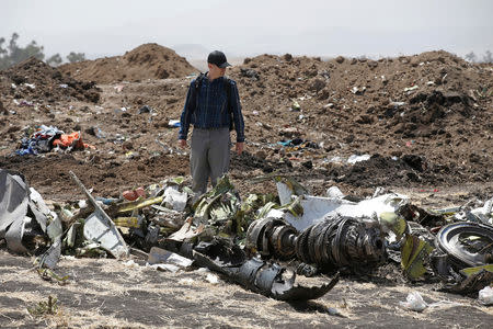 FILE PHOTO: American civil aviation and Boeing investigators search through the debris at the scene of the Ethiopian Airlines Flight ET 302 plane crash, near the town of Bishoftu, southeast of Addis Ababa, Ethiopia March 12, 2019. REUTERS/Baz Ratner/File Photo