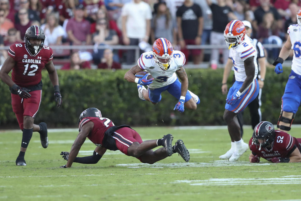 Florida wide receiver Eugene Wilson III (3) is tripped up by South Carolina defensive back Jalon Kilgore (24) during the second half of an NCAA college football game on Saturday, Oct. 14, 2023, in Columbia, S.C. (AP Photo/Artie Walker Jr.)