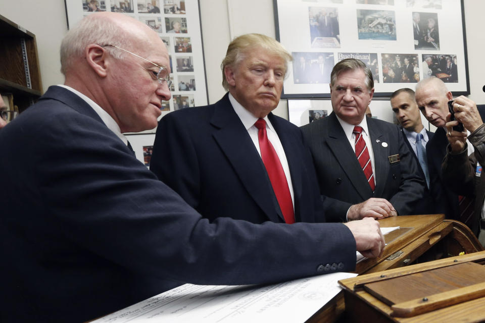 FILE— New Hampshire Secretary of State Bill Gardner, left, talks with Republican presidential candidate Donald Trump as Trump files his papers to be on the nation's earliest presidential primary ballot, Wednesday, Nov. 4, 2015, at the Statehouse in Concord, N.H. Gardner, the nation's longest serving secretary of state, announced Jan. 3, 2022 that he plans on stepping down as Secretary of State and not seek reelection to a 24th term. (AP Photo/Jim Cole, File)