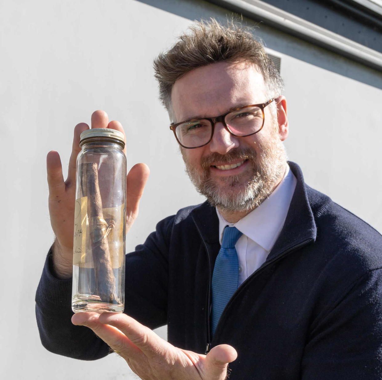 Charles Hanson, of Hansons Auctioneers, pictured with the cigar, which has been preserved in a jar for nearly 80 years (Mark Laban/Hansons/PA)