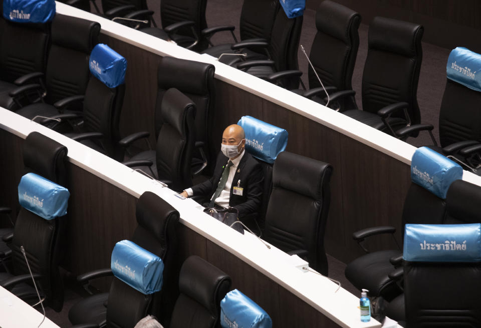 A member of the parliament Phanich Wikitset from the Democrat Party wears a face mask to help curb the spread of the coronavirus during an open session at the parliament house in Bangkok, Thailand, Wednesday, May 27, 2020. The parliament session Wednesday is the first since Thailand enforced coronavirus restrictions, and it was considered a special session to discuss the government’s plan to fund stimulus packages for businesses and industries impacted by the pandemic. (AP Photo/Sakchai Lalit)