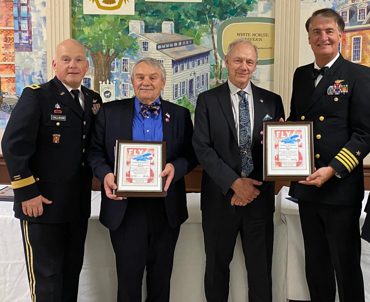 Maj. Gen. Chris Callahan, left, Rhode Island's adjutant general, and retired Navy Capt. Rich Suttie, right, an Aviation Hall of Fame Board member, flank brothers David and Skip Carter at the Hall of Fame's annual event Nov 18. David accepted an award on behalf of their father, Lynn, a WWII bomber pilot and Brown University graduate who died in 2014. Skip accepted his own award; a naval aviator, he flew combat missions off carrier decks in Vietnam and later became a commercial 747 captain.