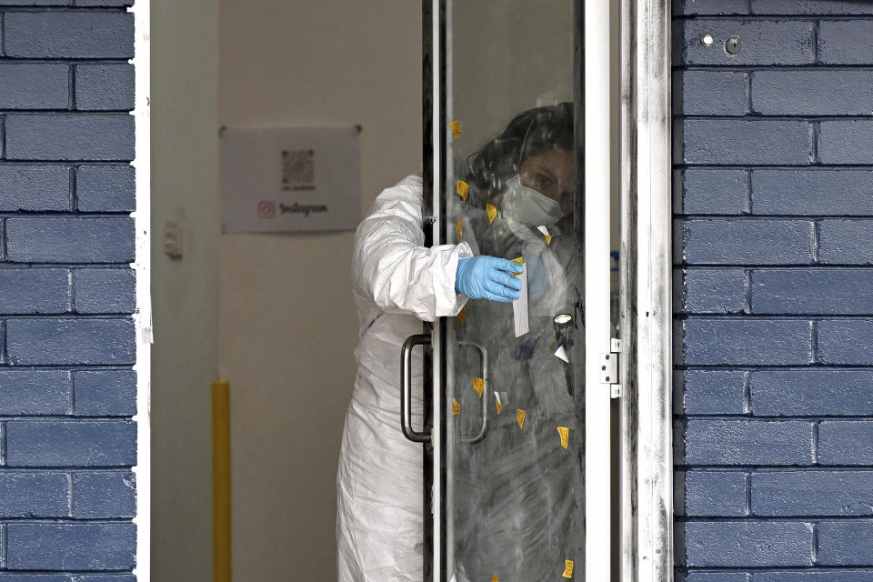 Police investigate at a crime scene in Sydney, Wednesday, Feb. 21, 2024. A taekwondo instructor killed a 7-year-old student at his academy and the boy's parents before going to a Sydney hospital with stab and slash wounds on his body, police said Wednesday. (Dan Himbrechts/AAP Image via AP)