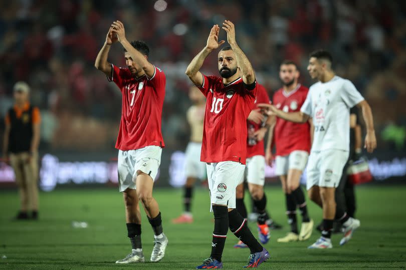 Mahmoud Trezeguet and Mohamed Salah of the Egypt team are celebrating after winning the match at a World Cup qualifying match between Egypt and Burkina Faso in Cairo, Egypt, on June 6, 2024.