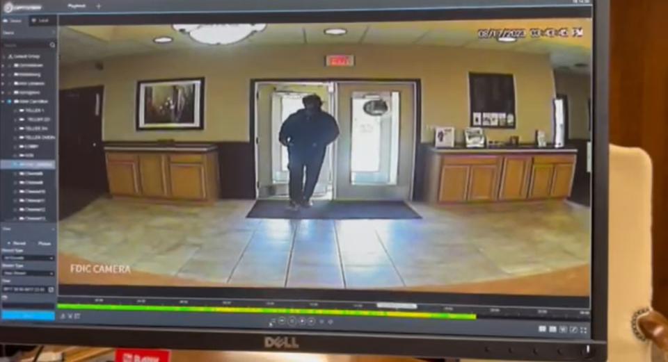 Farmers and Merchants Bank Robbery suspect entering and exiting