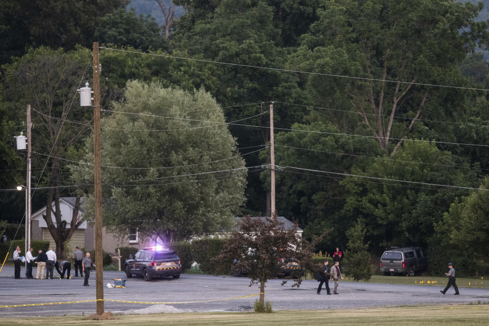 Law enforcement work the scene after a shooting near Mifflintown, Pa., Saturday, June 17, 2023. A state trooper and a suspect were both killed Saturday in a shootout in central Pennsylvania, hours after the suspect seriously wounded another trooper, state police said. (Sean Simmers/The Patriot-News via AP)