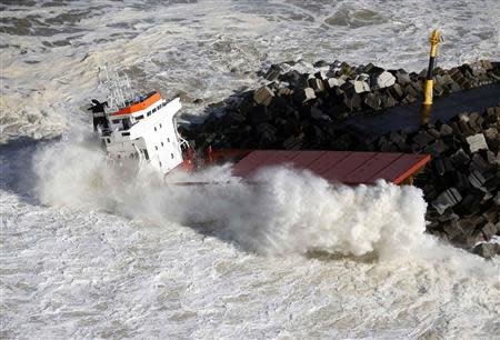 An aerial view show waves which break against a Spanish cargo ship carrying fertiliser, broken in two, off the beach in Anglet on the Atlantic Coast of France, February 5, 2014. REUTERS/Regis Duvignau