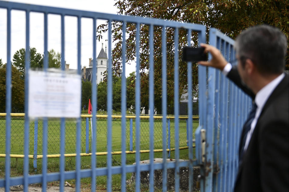 Independent lawmaker Akos Hadhazy, who has made a name for himself in Hungary as an anti-corruption crusader, snaps pictures of the 19th century Tura castle, owned by the son-in-law of Hungarian prime minister Viktor Orban in Tura, Hungary, Wednesday, Sept. 14, 2022. Orban is facing a reckoning with the EU, which appears set to impose financial penalties on Hungary over corruption concerns and alleged rule-of-law violations that could cost Budapest billions and cripple its already ailing economy. (AP Photo/Anna Szilagyi)