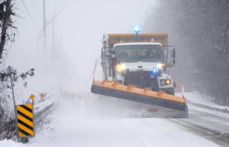 A snow plow clears a section of road in Ottawa, Tuesday, Jan. 9, 2024. 