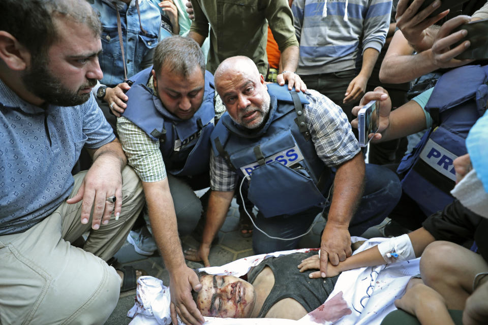 Al-Jazeera correspondent Wael Dahdouh mourns his son killed in an Israeli airstrike at Nuisserat refugee camp, outside a hospital in Deir al Balah, south of the Gaza Strip, Thursday, Oct. 26, 2023. Dahdouh's wife, son, daughter, and grandson were killed in the strike. (AP Photo/Ali Mahmoud)