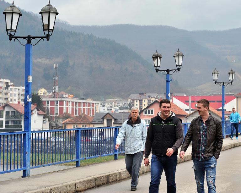 22-year-old Bosnian Alen Muhic (C) walks with a friend in Gorazde on March 27, 2015, after the premierre of the documentary film "An Invisible Child's Trap"