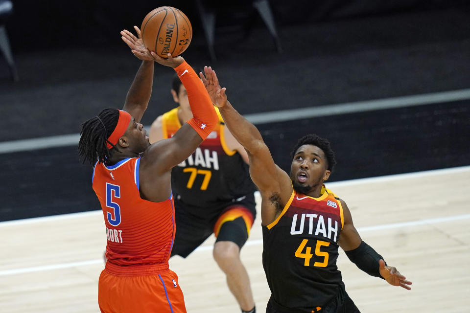 Oklahoma City Thunder forward Luguentz Dort (5) shoots as Utah Jazz guard Donovan Mitchell (45) defends during the second half of an NBA basketball game Tuesday, April 13, 2021, in Salt Lake City. (AP Photo/Rick Bowmer)