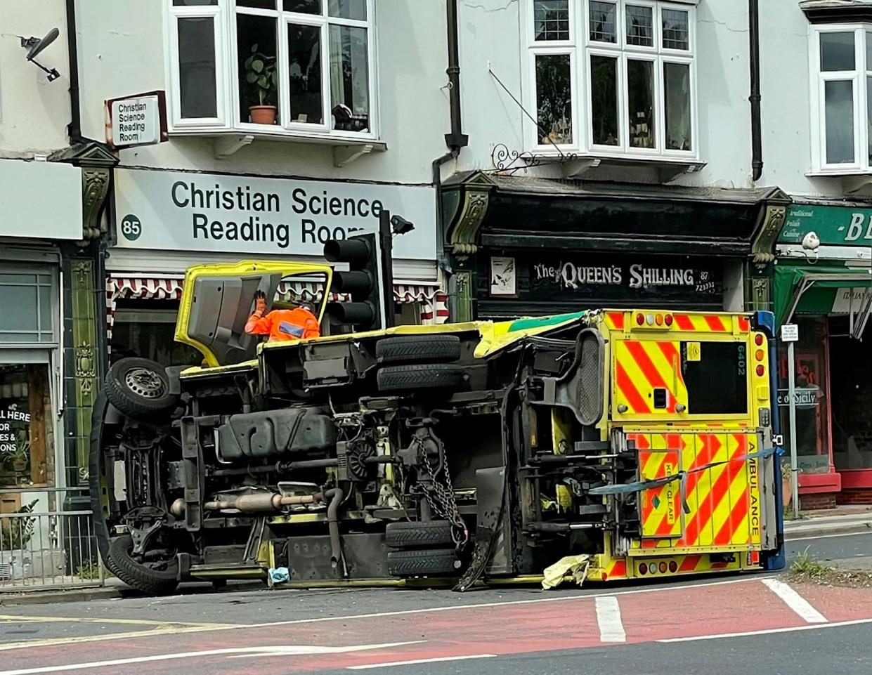 These dramatic pictures show an ambulance on its side after a crash at traffic lights.  See SWNS story SWBRambulance.  The response vehicle was left damaged after colliding with a car at a busy junction.  Police and fire crews were called to the scene of the collision on the A35 in Ashley Cross in Poole, Dorset, this afternoon. (Fri).  Road closures were put in place for the recovery of the vehicle and clean-up of the scene.  Pictures also showed members of the public climbing on top of the ambulance to try and help paramedics get out. 