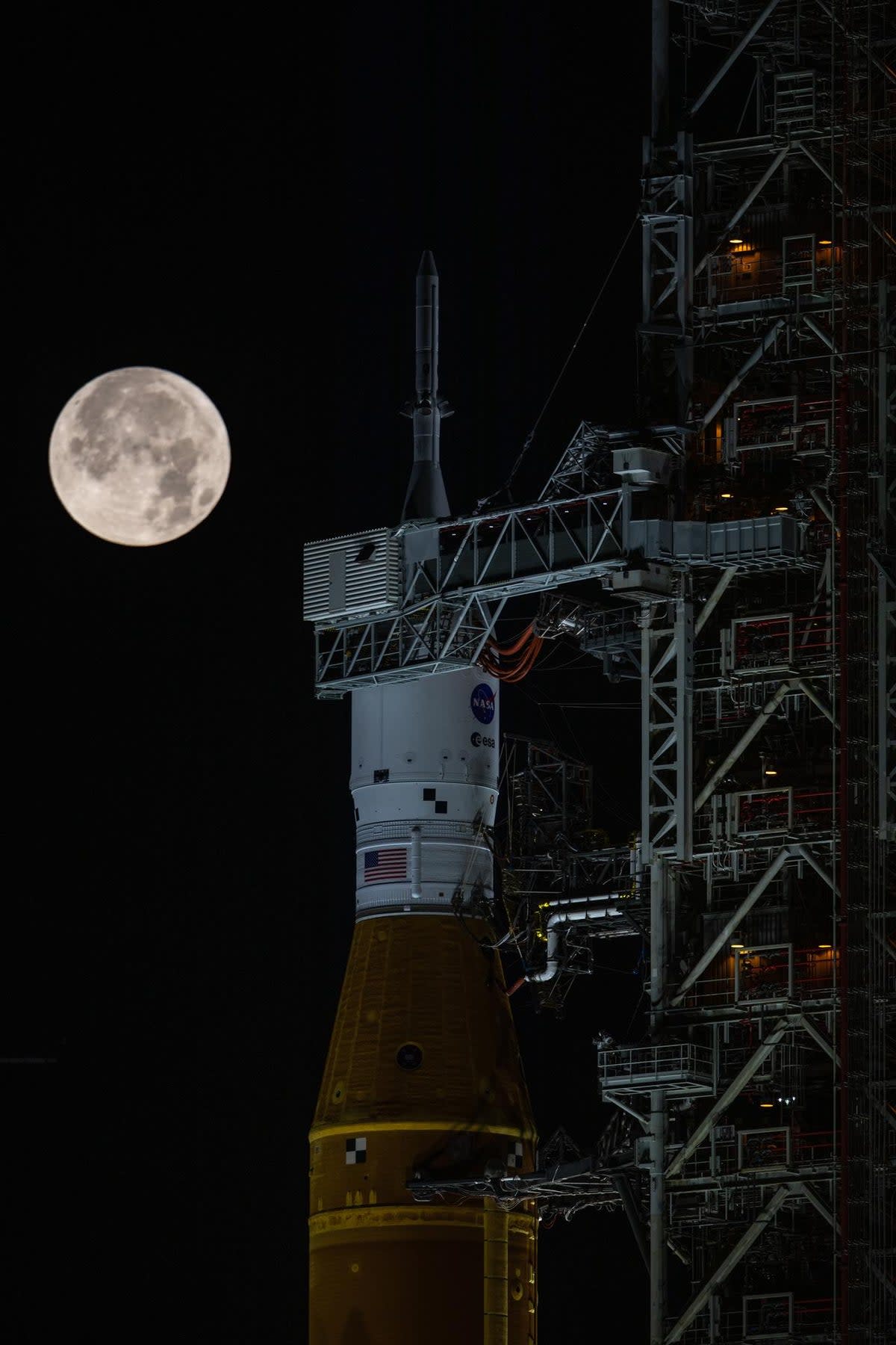 Nasa’s Artemis I mission — the Space Launch System rocket and Orion spacecraft — on the launch pad at Kennedy Space Center beneath a full Moon.  (Nasa)