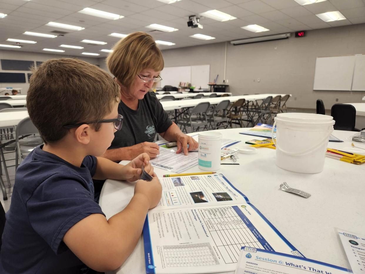 Volunteer mentor Mary Smith works with a child involved in a Boys & Girls Clubs of Topeka program that teaches youngsters about "STEM," which is science, technology, engineering and math.