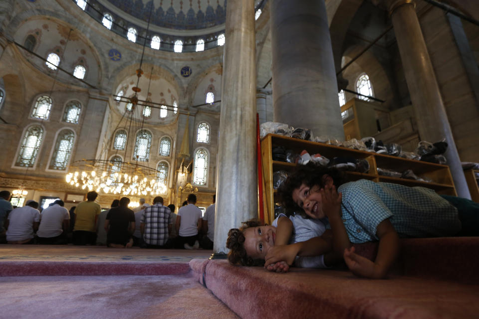 Children play in a mosque before prayers in Istanbul, Turkey on Wednesday, Aug. 15, 2018. Turkey is deeply divided between Erdogan’s pious Muslim base and secular Turks who once held sway over the country, but opposition voices have been mostly muted as Erdogan, who has concentrated power in a new presidential system of government, projects an image of a righteous state under siege. (AP Photo/Lefteris Pitarakis)