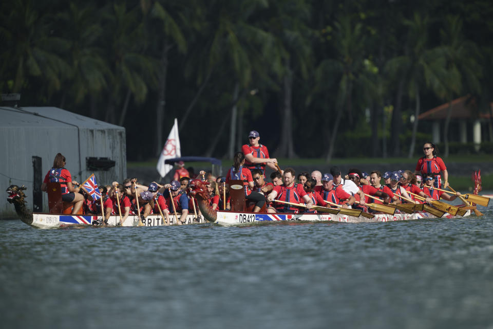 Britain's Prince William, seated center on boat at right, participates in a dragon boat event in Singapore, Monday, Nov. 6, 2023. (AP Photo/Vincent Thian)