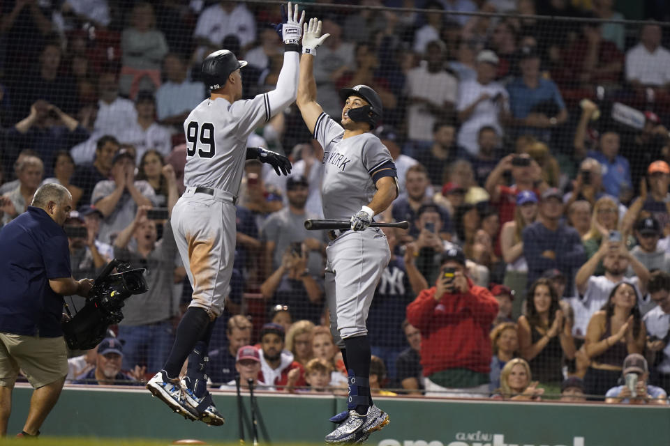 New York Yankees' Aaron Judge (99) celebrates his home run against the Boston Red Sox with Giancarlo Stanton, right, during the sixth inning of a baseball game Tuesday, Sept. 13, 2022, in Boston. (AP Photo/Steven Senne)