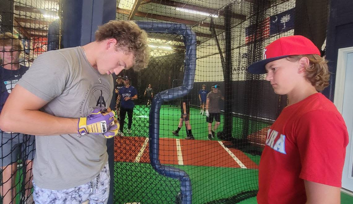 Hammond School’s Tucker Toman, left, signs an autograph at Carolina Playmakers facility in Columbia, SC, on Monday, July 11, 2022.