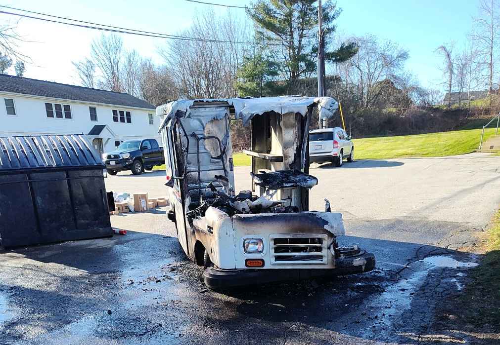 The remnants of a burned out U.S. Postal Service delivery vehicle that caught fire Friday in Dudley.