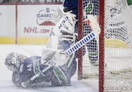 Vancouver Canucks goalie Braden Holtby stops Toronto Maple Leafs' Wayne Simmonds during the third period of an NHL hockey game in Vancouver, British Columbia, Sunday, April 18, 2021. (Darryl Dyck/The Canadian Press via AP)