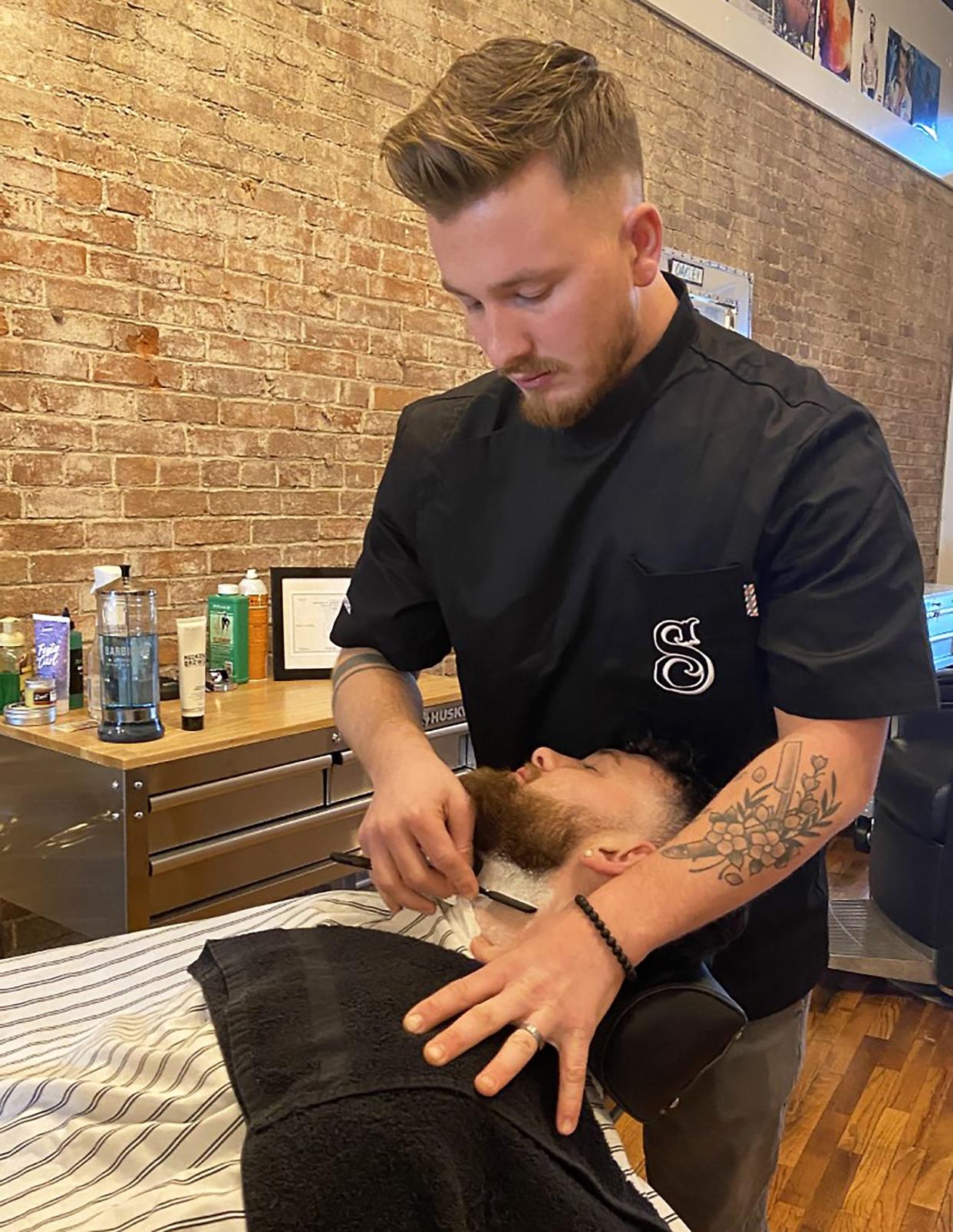 Oakley Stevens at work at Stevens Bros. Barber Co.