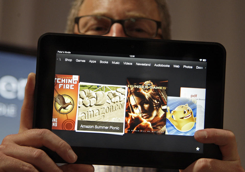 Amazon Kindle vice president Peter Larsen holds the Kindle Fire HD at the introduction of the new Kindle devices in Santa Monica, Calif., Thursday, Sept. 6, 2012. (AP Photo/Reed Saxon)