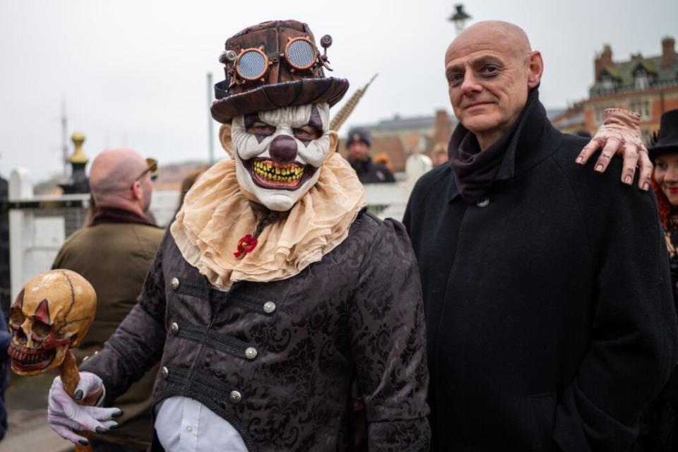 Two men in costume walk across Whitby swing bridge during the Whitby Goth Weekend on April 29, 2023 in Whitby, England. (Photo by Ian Forsyth/Getty Images)